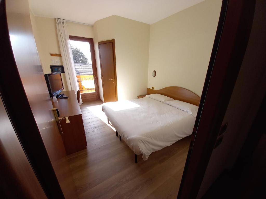 Postel nebo postele na pokoji v ubytování Hotel Prealpi