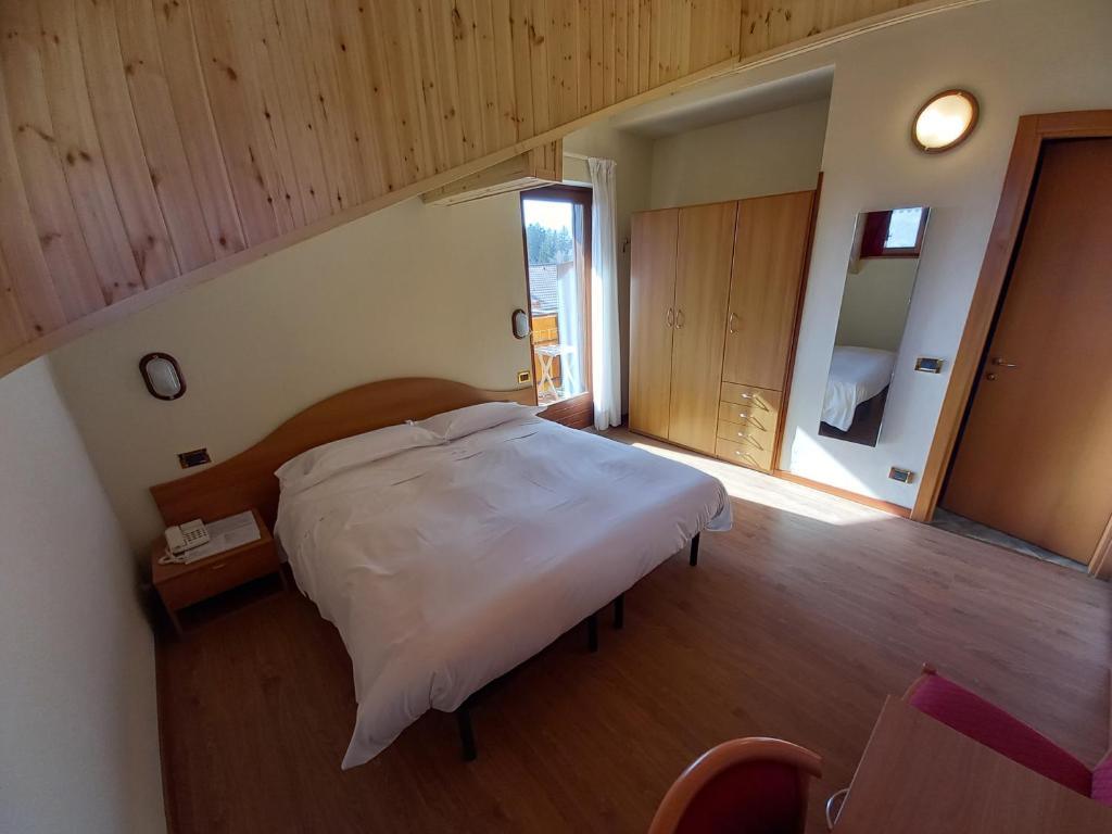 Postel nebo postele na pokoji v ubytování Hotel Prealpi
