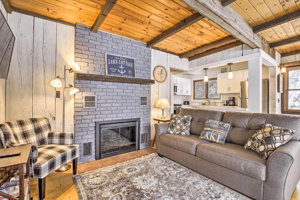 a living room with a couch and a fireplace at Lakefront Granby Escape with Private Dock and Kayaks! in Granby
