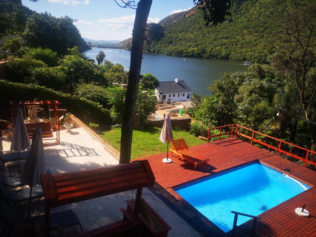 a swimming pool with a view of a river at Metsing at Harties in Hartbeespoort