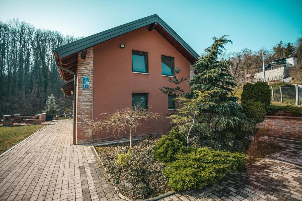 a house with a christmas tree in front of it at Vila Cherry in Tuheljske Toplice