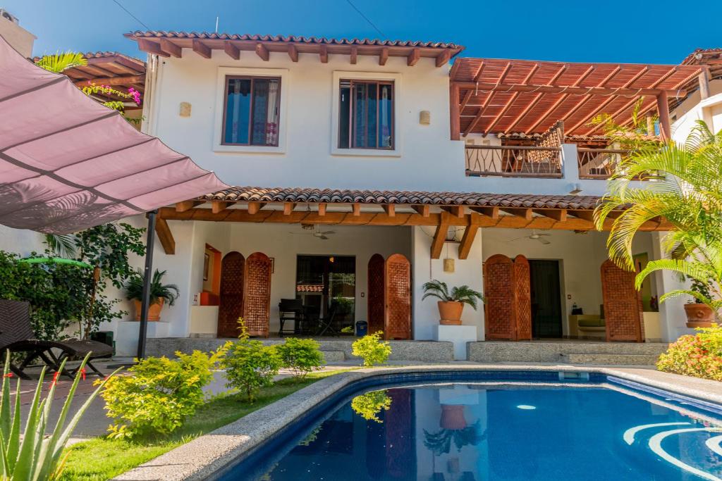 Villa con piscina frente a una casa en Villas Sunrisa, en Zihuatanejo