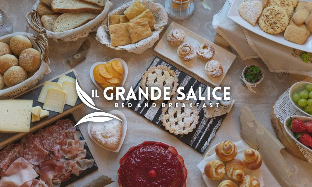 a table filled with different types of bread and pastries at BB Il Grande Salice Bike Friends in Ponti Sul Mincio