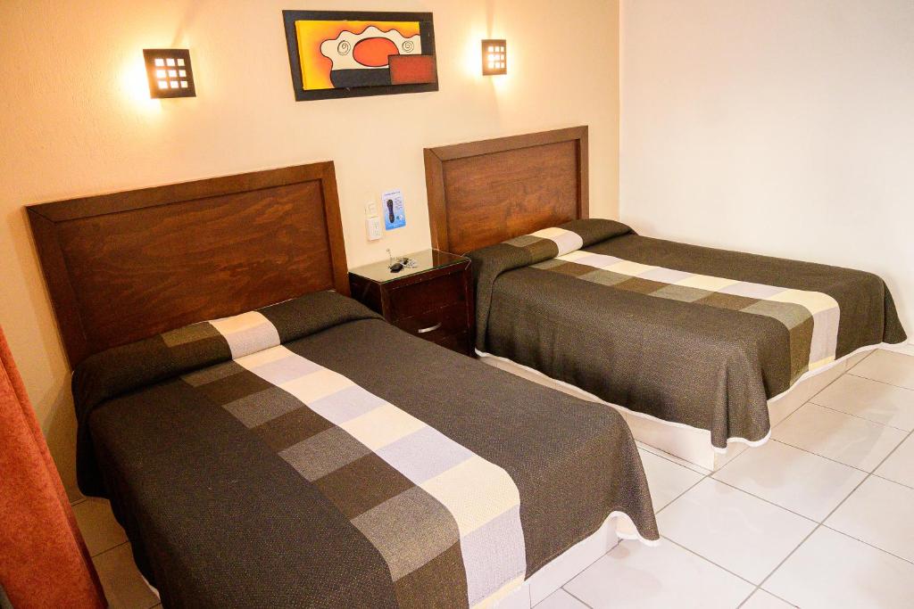 Postel nebo postele na pokoji v ubytování Hotel Acuario En Ocotlán