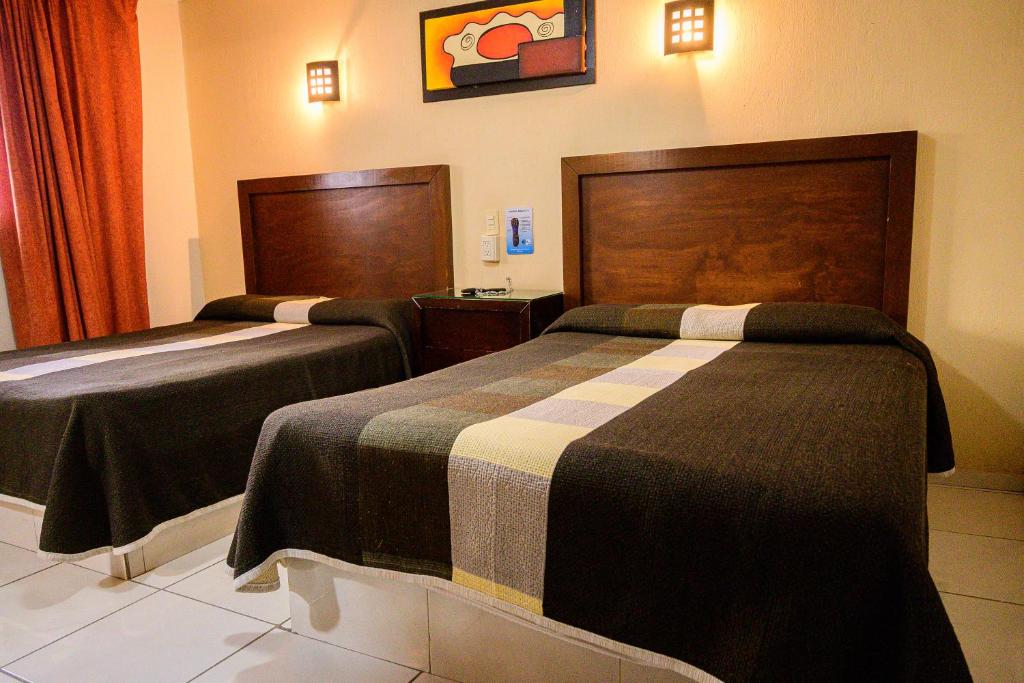 Postel nebo postele na pokoji v ubytování Hotel Acuario En Ocotlán