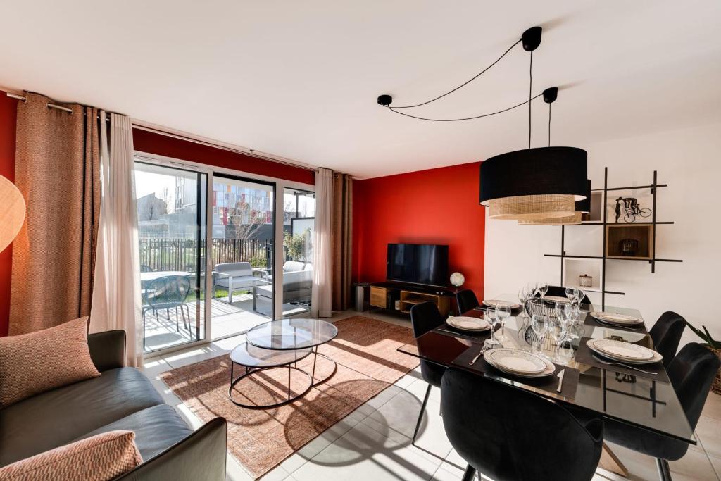 安錫的住宿－Le Reposoir - New 2 bedroom apartment with terrace & garage，客厅设有红色的墙壁和桌椅