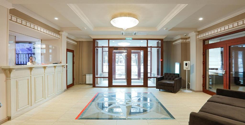 a lobby with a glass table in the middle of a room at Aparthotel Izmaylovskiy park (Home Hotel) in Moscow