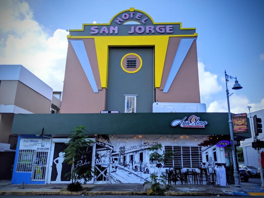 a building with a clock on the front of it at Hotel San Jorge in San Juan