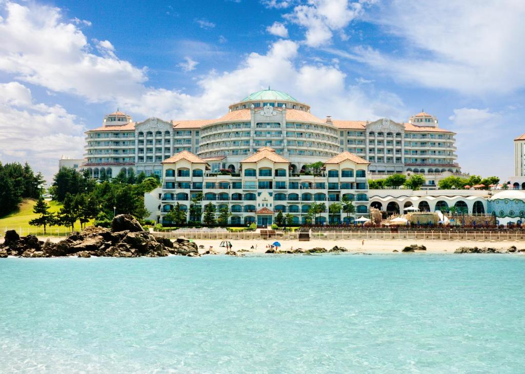 a large building on the beach in front of the water at Sol Beach Yangyang in Yangyang