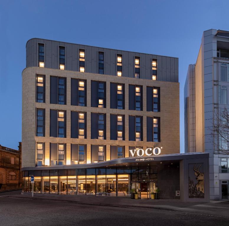 a large building with a clock on the front of it at voco Edinburgh - Haymarket, an IHG Hotel in Edinburgh