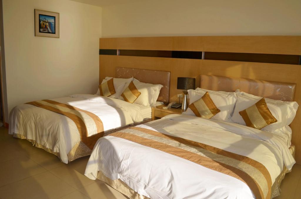 Postel nebo postele na pokoji v ubytování Yake Homestay