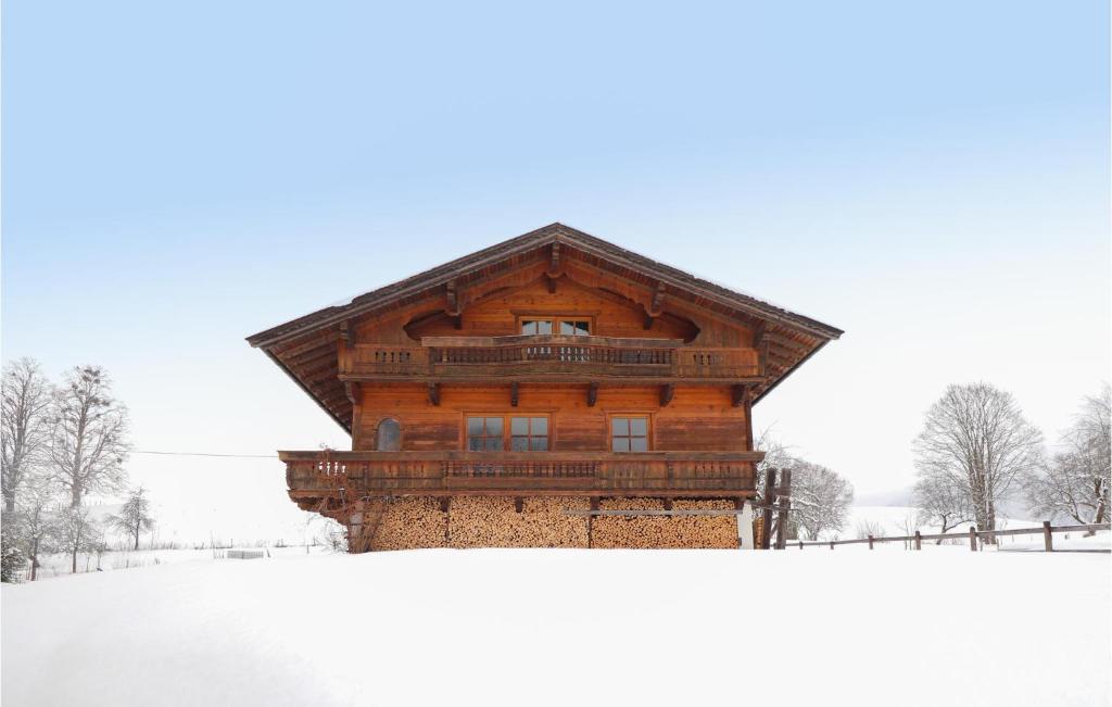 a large wooden building in the snow with snow at Beautiful Home In Ebbs With House A Panoramic View in Rettenschöss