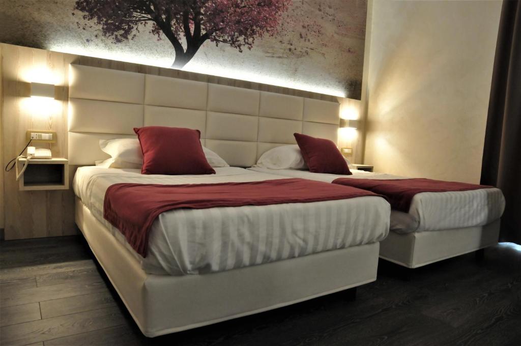 Postel nebo postele na pokoji v ubytování Hotel Aquila