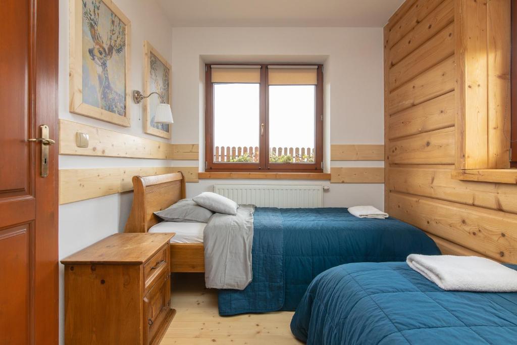 Posteľ alebo postele v izbe v ubytovaní Apartamenty Domino - Kościelisko