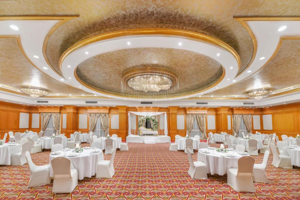a large banquet hall with white tables and chairs at Tolip Aswan Hotel in Aswan