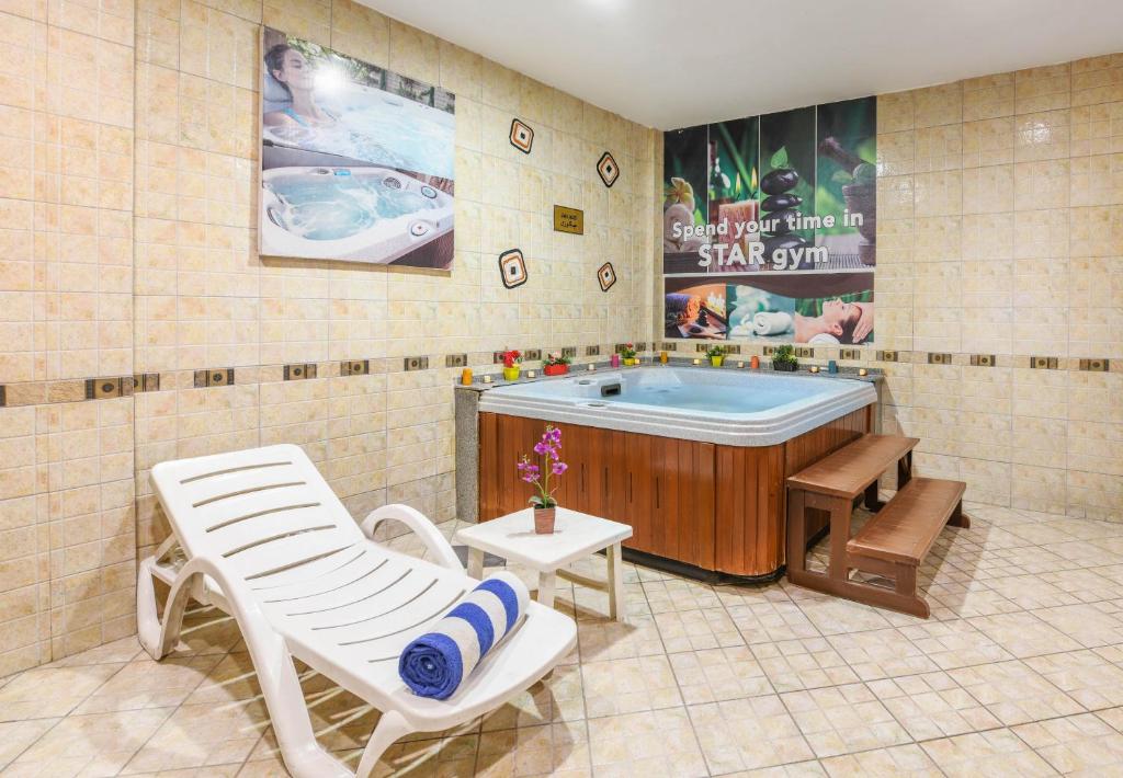 a rendering of a bathroom with a tub and a chair at Tolip Aswan Hotel in Aswan