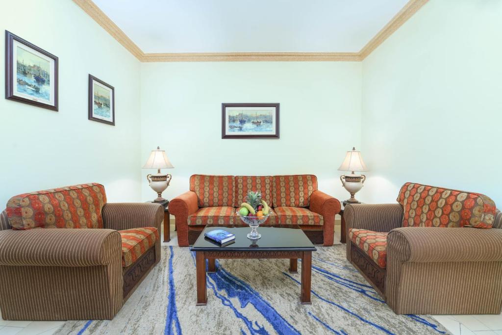 a living room with couches and a coffee table at Tolip Aswan Hotel in Aswan
