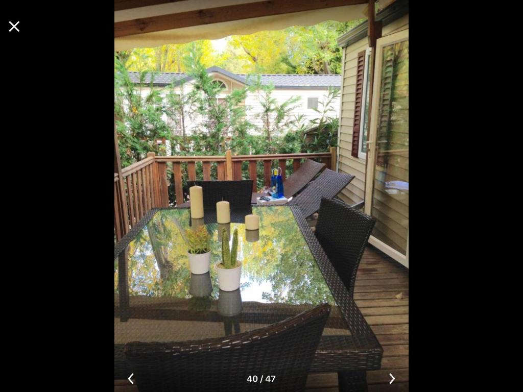 a patio with a table and chairs on a deck at Best Holiday Port Grimaud in Grimaud