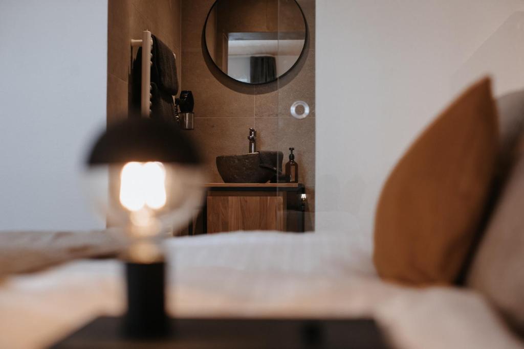una lámpara sentada en una mesa frente a un espejo en House 55, en Sölden