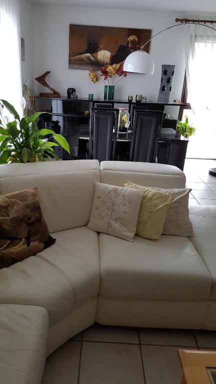 a white couch with pillows in a living room at 24 rue St Exupery in Gap
