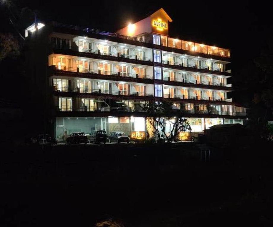 a lit up hotel building at night with lights at Resort The Alpine in Lansdowne