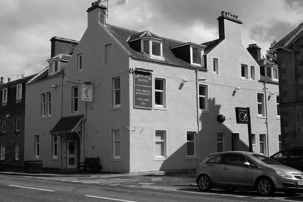 a small car parked in front of a building at The Aberlour Hotel in Aberlour