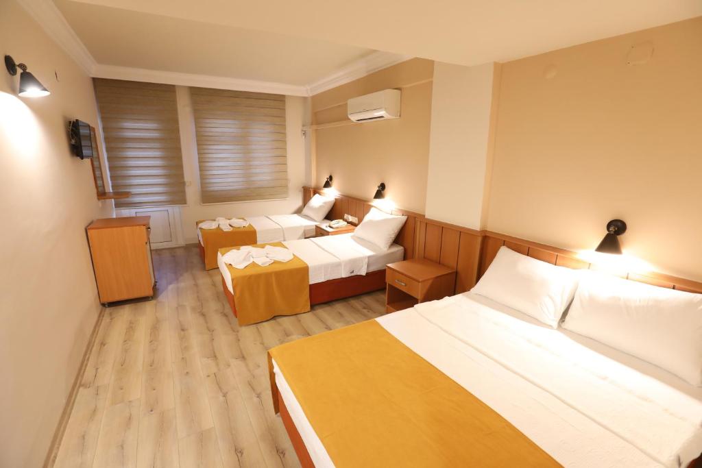 A bed or beds in a room at Luna Piena Hotel