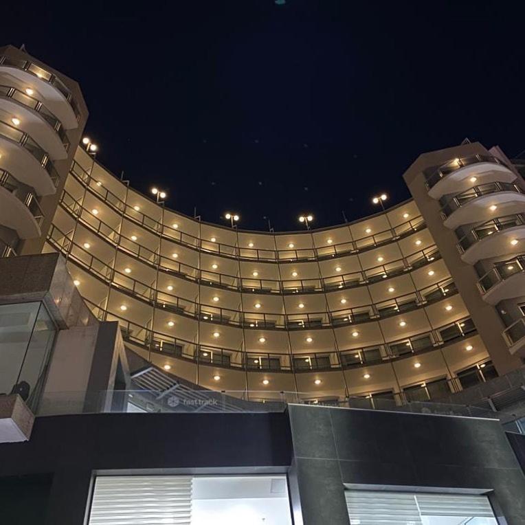 a large building with lights on it at night at The Preluna Hotel in Sliema