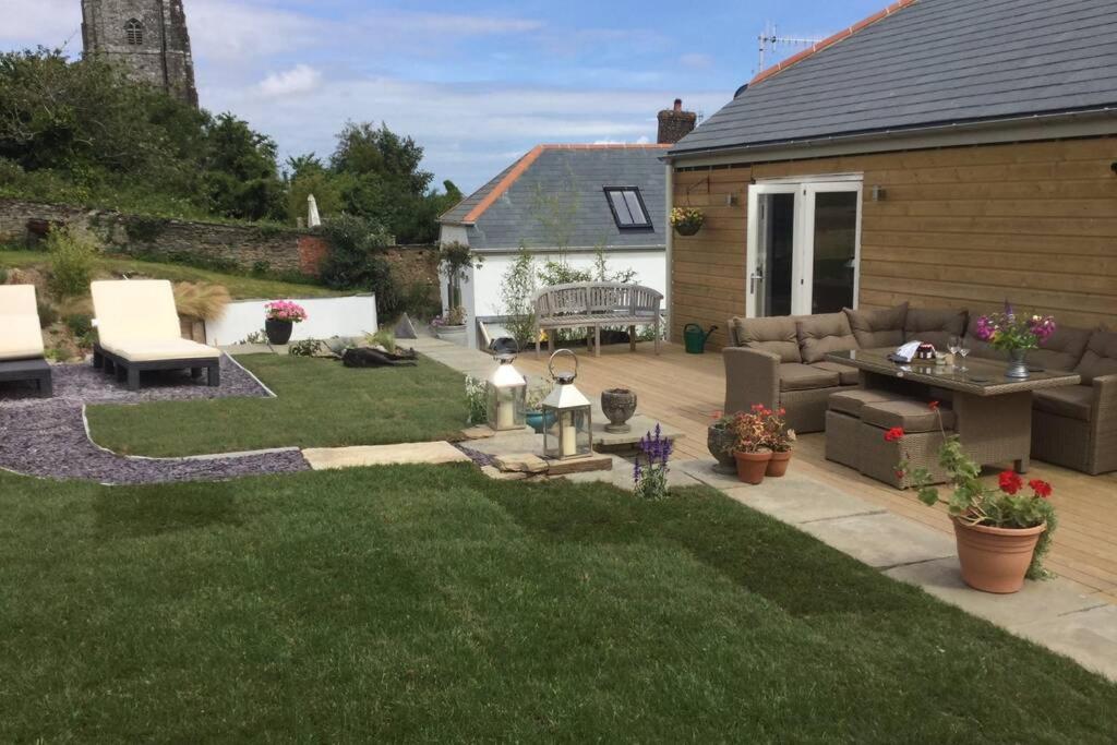 a backyard with a patio and a lawn at Horsemans Barn in Kingsbridge