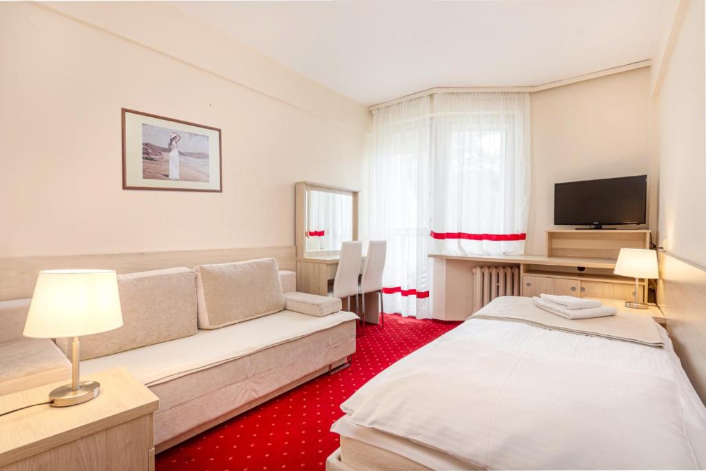 Postel nebo postele na pokoji v ubytování Hotel Ustka