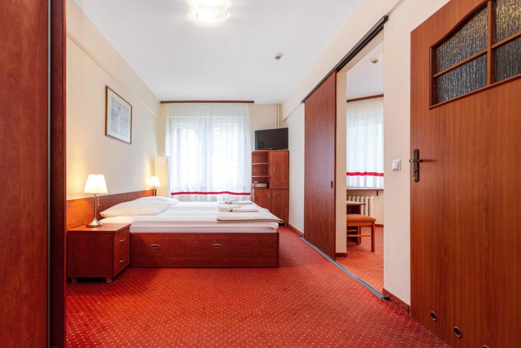 Postel nebo postele na pokoji v ubytování Hotel Ustka