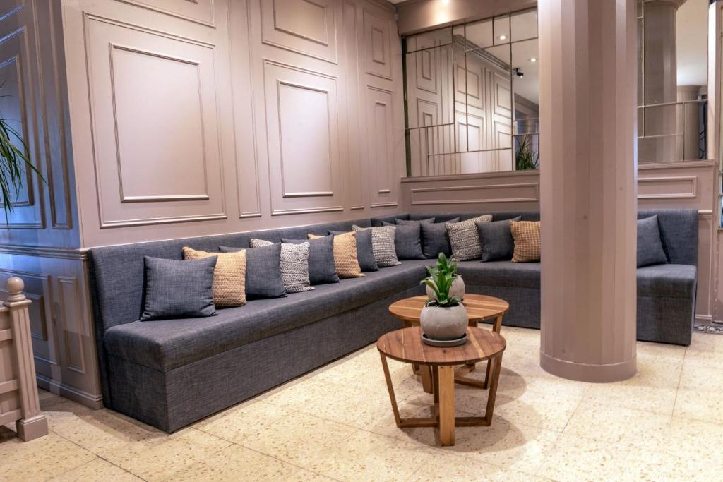 a living room with a couch and a table at Gran Hotel Panamericano in Mar del Plata