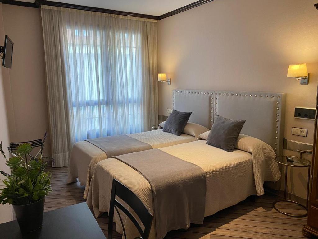 Postel nebo postele na pokoji v ubytování Hotel Los Molinos