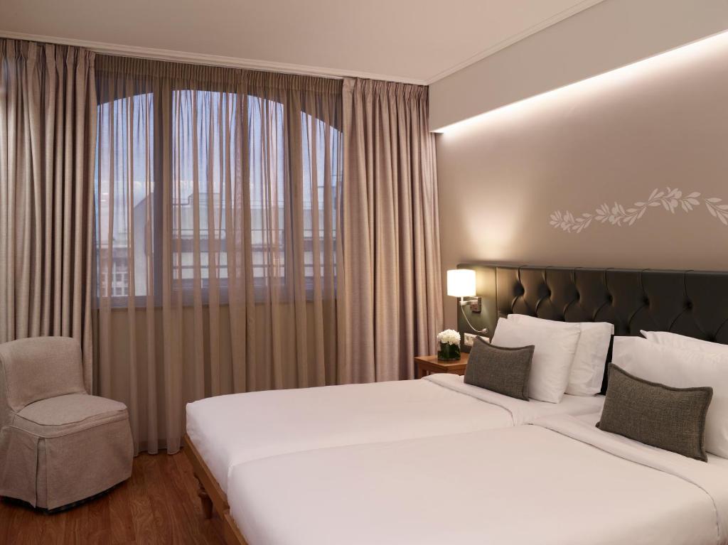 Postel nebo postele na pokoji v ubytování Titania Hotel
