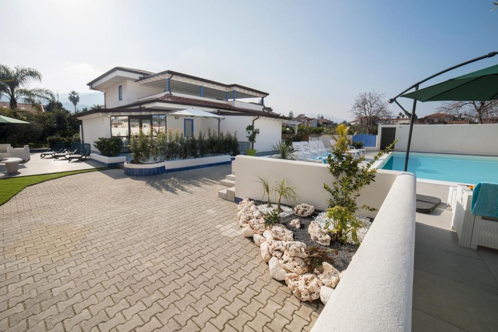 une villa avec une piscine et une maison dans l'établissement Villa Concettina, à Capo dʼOrlando