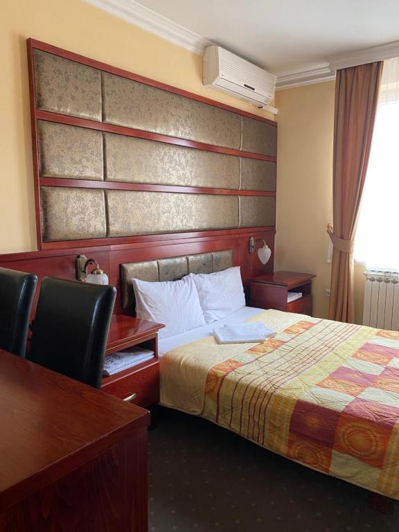 a hotel room with a bed and a desk at Hotel Kamel in Banja Luka
