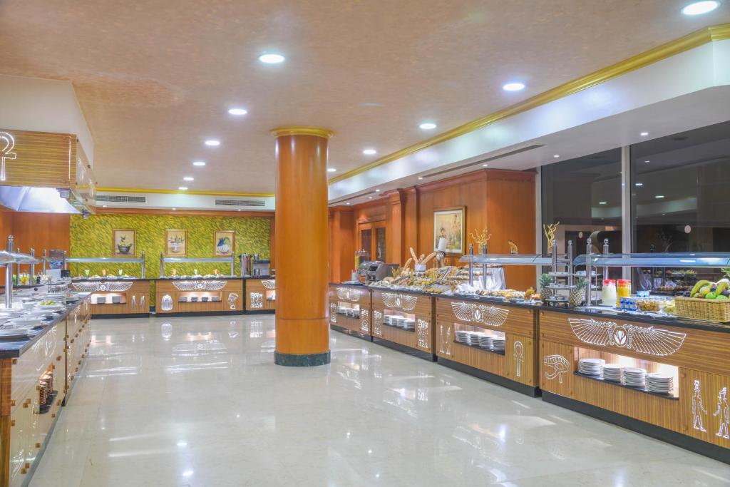 a restaurant with a buffet line in a building at Tolip Aswan Hotel in Aswan