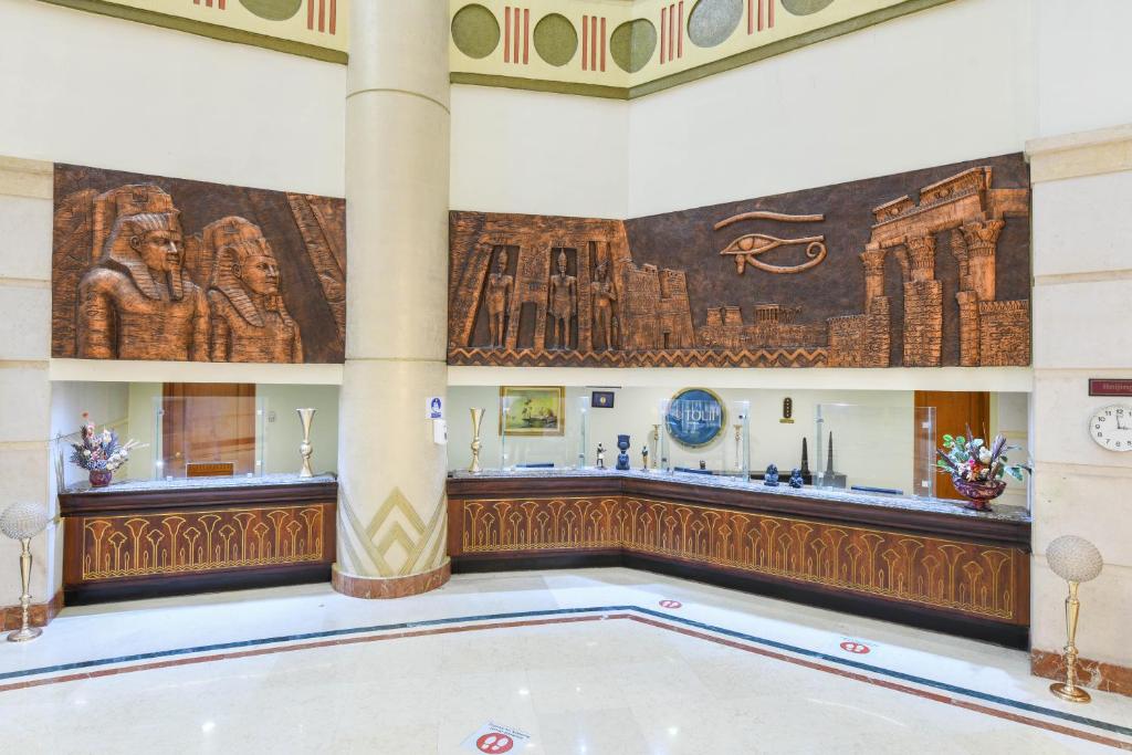 a swimming pool in a building with a painting on the wall at Tolip Aswan Hotel in Aswan
