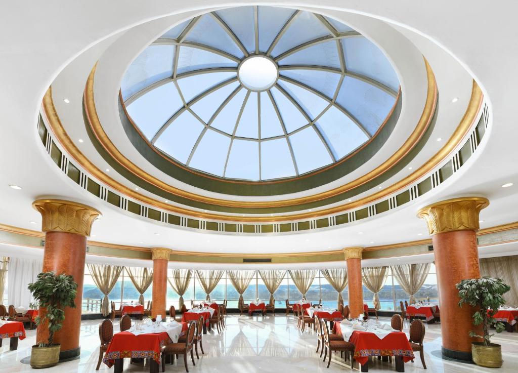 a large dining room with a large glass ceiling at Tolip Aswan Hotel in Aswan