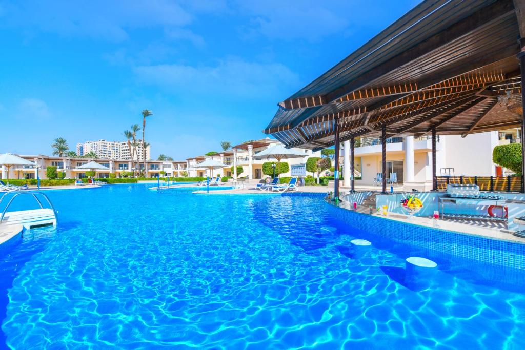 a swimming pool at a resort with blue water at Tolip Aswan Hotel in Aswan