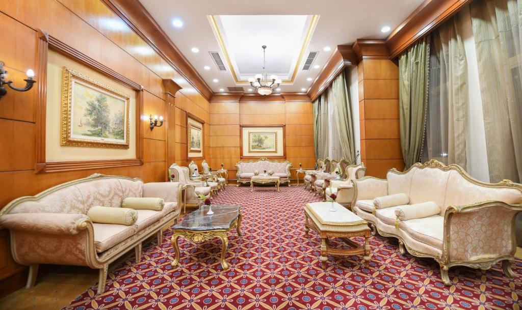 a living room with couches and chairs and a table at Tolip Aswan Hotel in Aswan