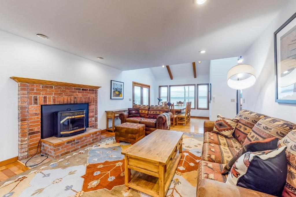 a living room with a couch and a fireplace at Shine Road Retreat in Port Ludlow