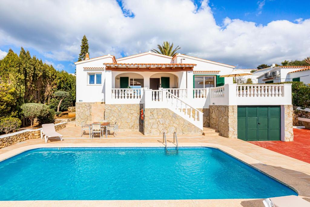a villa with a swimming pool and a house at Villa Dreams in Son Bou