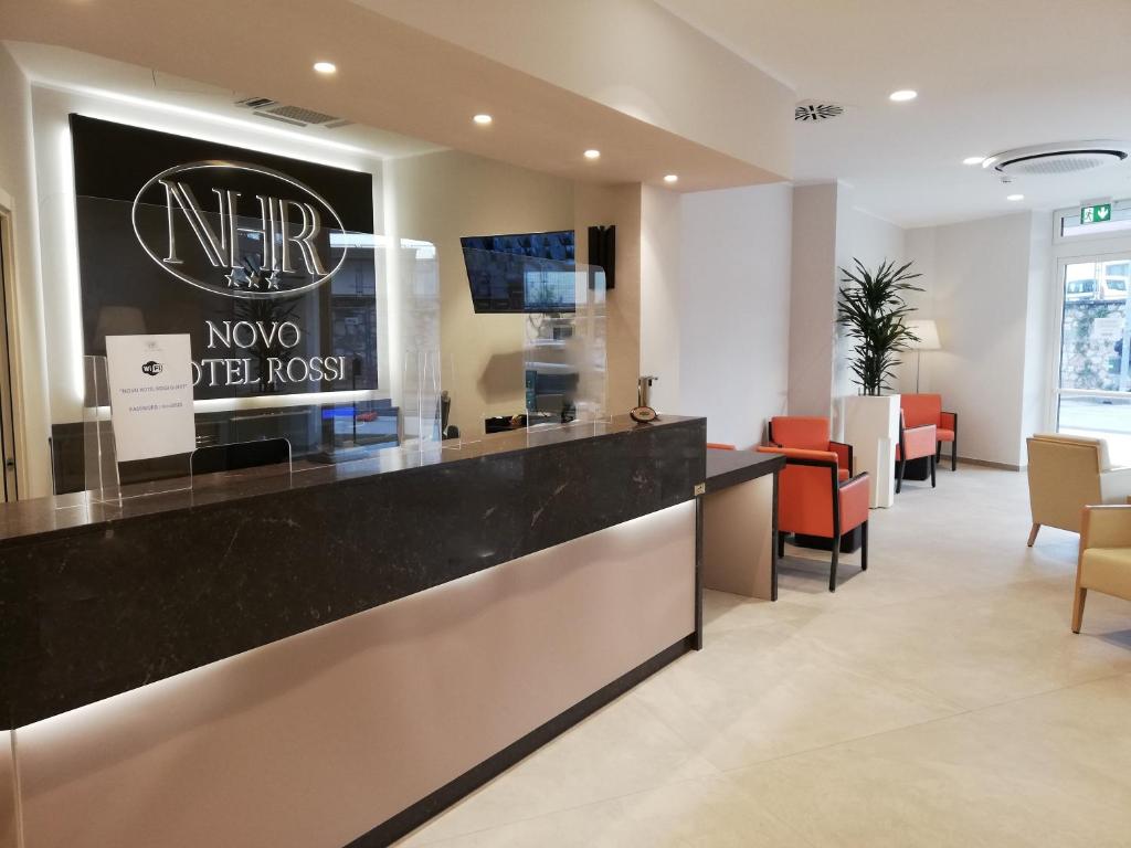 a lobby of a hotel with a counter and chairs at Novo Hotel Rossi in Verona