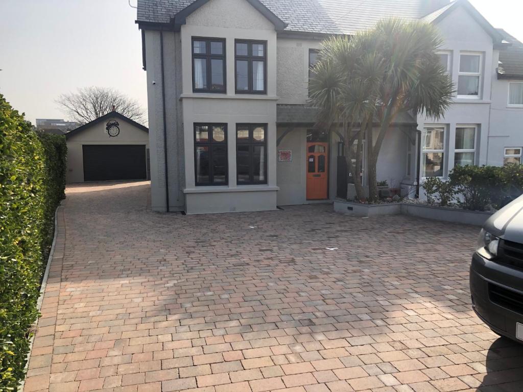a house with a brick driveway in front of it at Bedlam House in Newquay