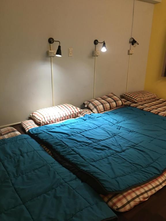 Postel nebo postele na pokoji v ubytování 稻禾民宿