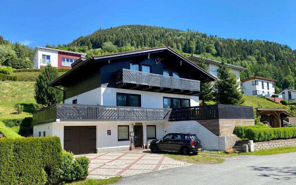 a house with a car parked in front of it at Chalet on the Rood Zell am See Kaprun in Piesendorf