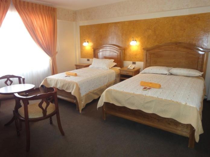 A bed or beds in a room at HOTEL MAISON FIORI (Plaza Colon)