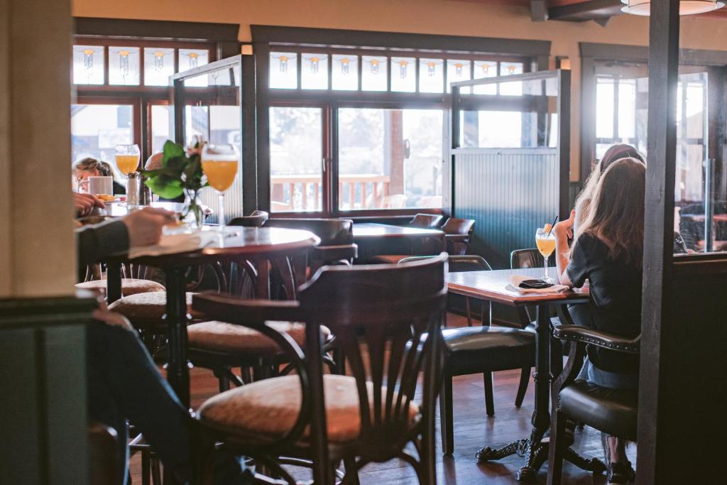 a group of people sitting at tables in a restaurant at Salt Spring Inn in Ganges