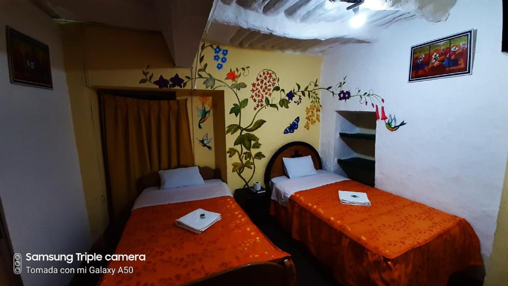 Postel nebo postele na pokoji v ubytování Hostal sambleño cusco Piero suite